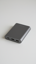 A durable and stylish power bank in 'Dim Gray', perfectly centered on a 'White Smoke' background. Photographed with a 50mm...